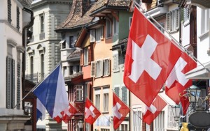 Above: An old street in Zurich decorated with flags for the Swiss National (Photo credit: Alexander Chaikin/Shutterstock)