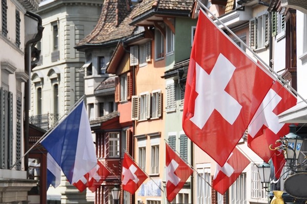 Above: An old street in Zurich decorated with flags for the Swiss National (Photo credit: Alexander Chaikin/Shutterstock)