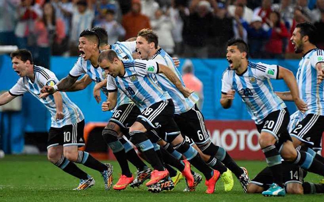 Argentina charge the field after their penalty shootout against the Netherlands