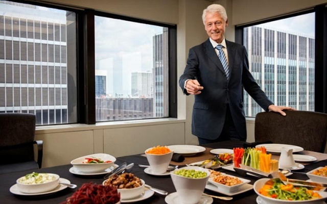 Bill Clinton shows off an all-veggie lunch spread (Photo: Ben Baker/AARP The Magazine)