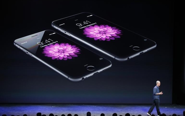 Above: Apple CEO Tim Cook on stage during Apple's announcement of the iPhone 6 and the iPhone 6 Plus at the Flint Center in Cupertino, California, September 9, 2014