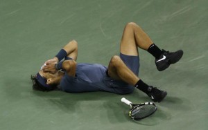 Rafael Nadal falls to the court after defeating Novak Djokovic (Photo: Julio Cortez/AP)