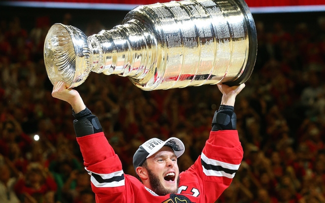 Above: Blackhawks captain Jonathan Toews celebrates by hoisting the Stanley Cup after defeating the Tampa Bay Lightning