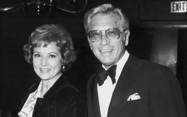 19th March 1974: American actor Betty White stands smiling with her husband, TV producer and host Allen Ludden (d. 1981), wearing a tuxedo, at an International Broadcasting Awards dinner tribute to Mary Tyler Moore. (Photo by Frank Edwards/Fotos International/Getty Images)